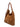 Three-quarter view of a cognac BAMBURI suede hobo bag with leather handle and gold-tone rings
